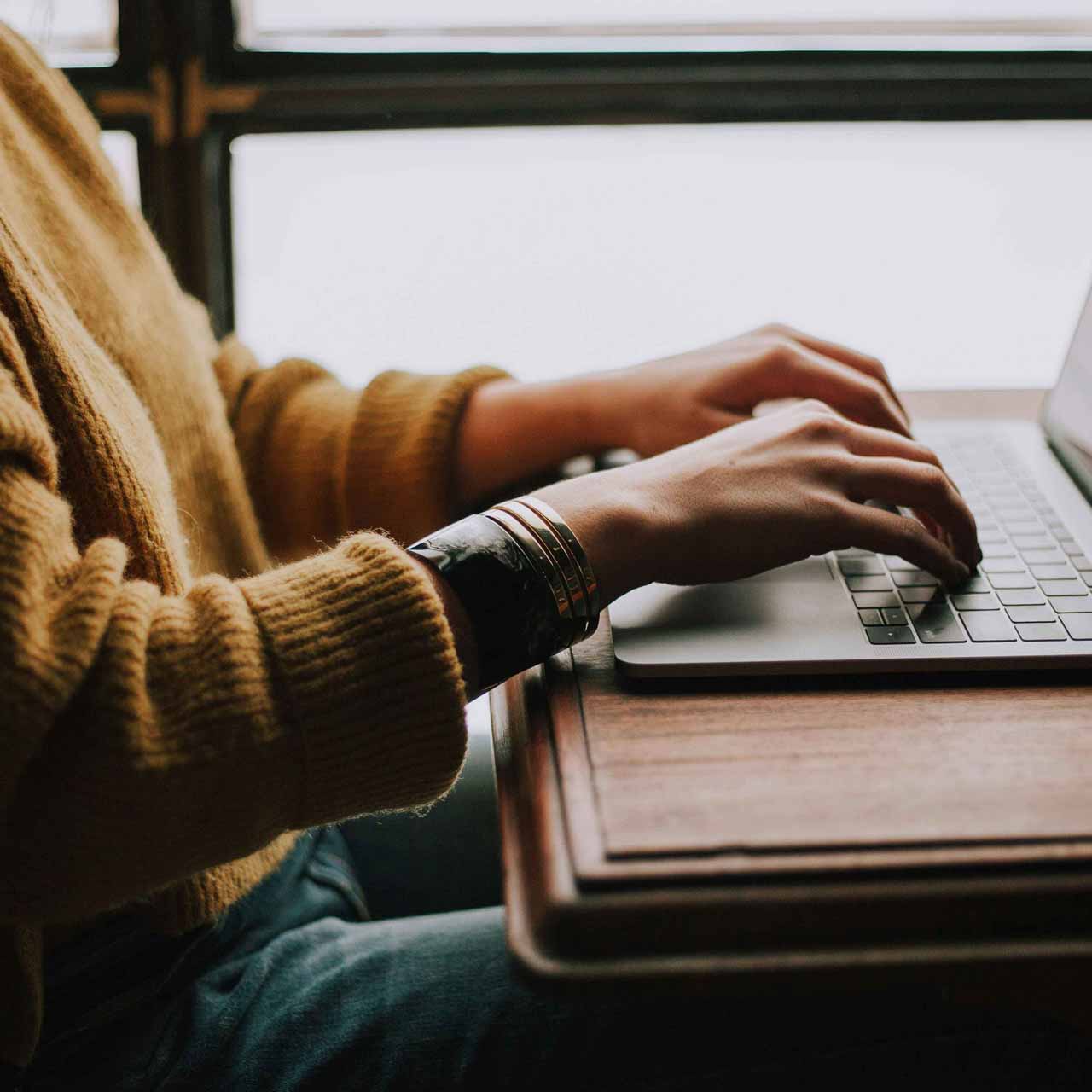 Woman typing on her laptop